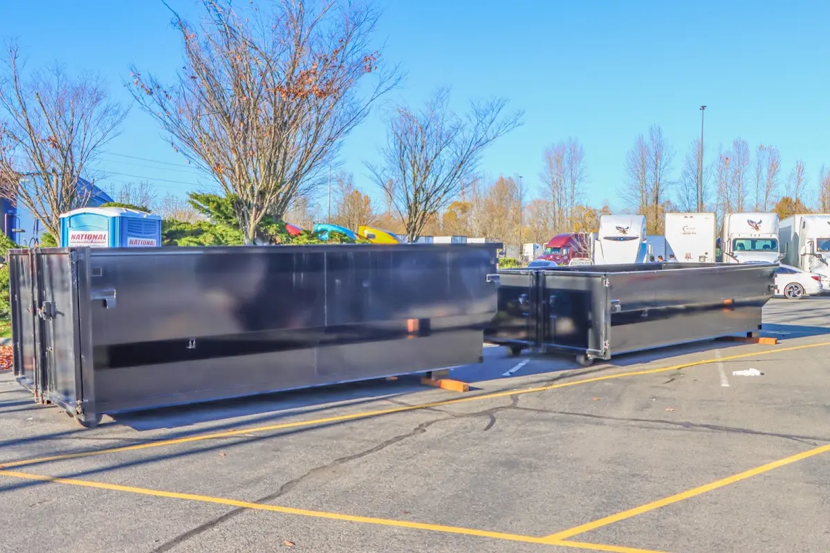 Professional dumpster rental service with roll-off container on residential driveway in North Adams